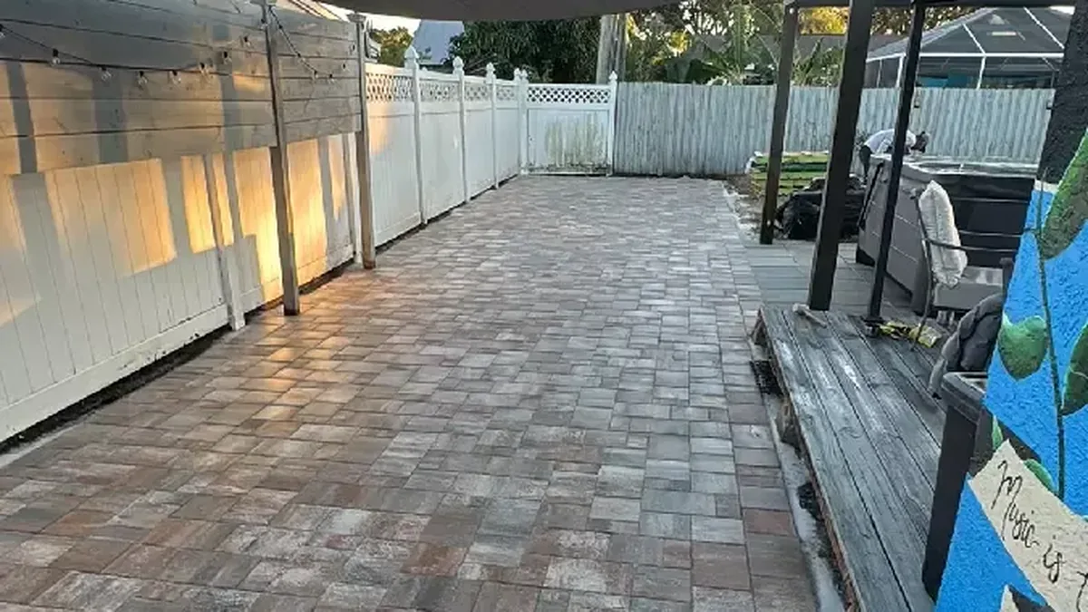 Sealed concrete paver back patio running alongside a home in Venice, Florida