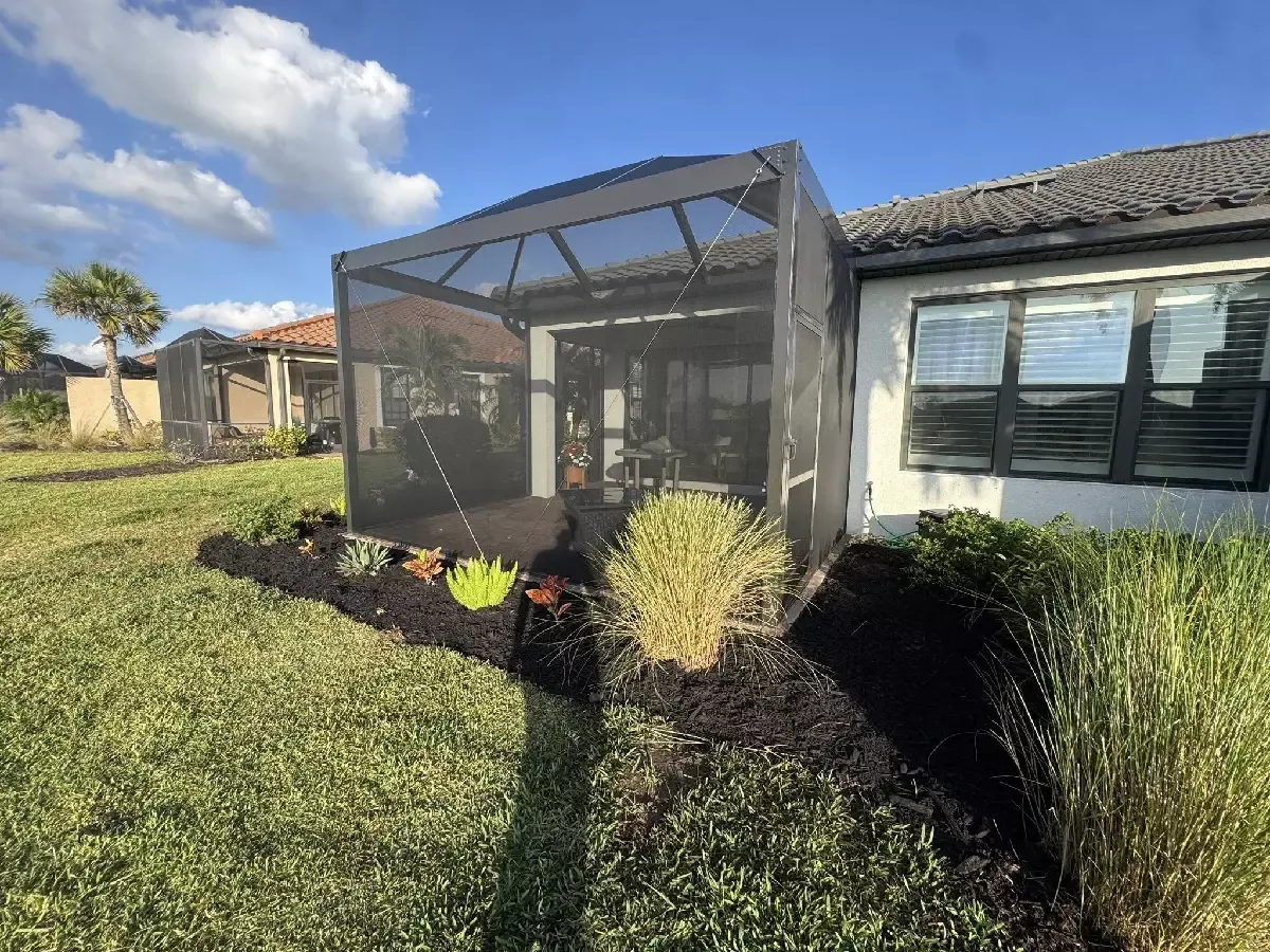 Screened lanai extension with a completed concrete paver floor in Bradenton, Florida