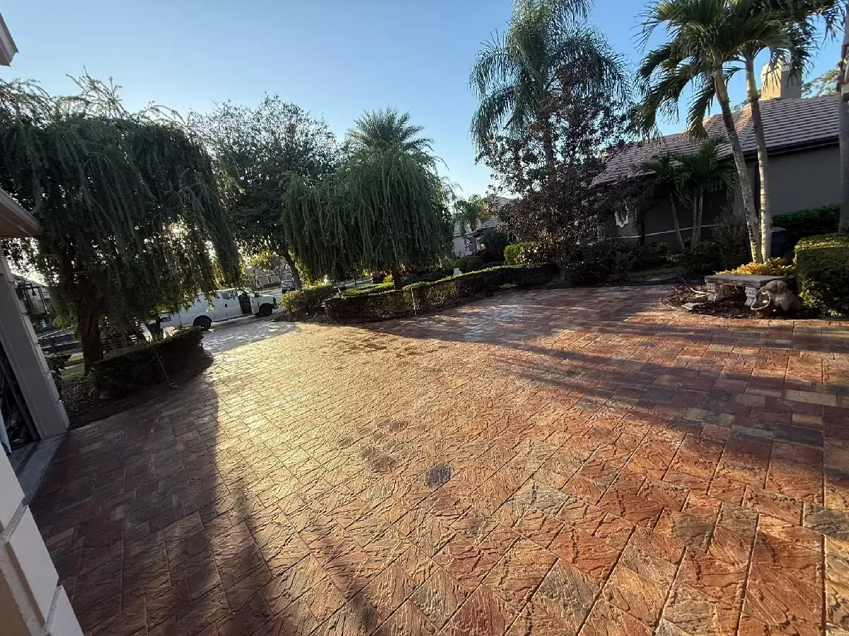 Brick paver driveway framed by palm trees at a Bradenton, Florida property