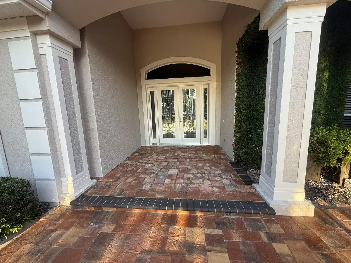 Brick paver entrance under a columned portico at a Bradenton, Florida home