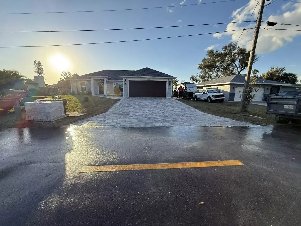 Finished gray concrete paver driveway with a dark border at a Nokomis, Florida home