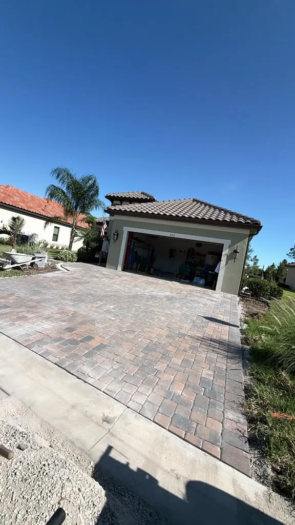 Tremron Driftwood Olde Town paver driveway leading to a garage in Nokomis, Florida