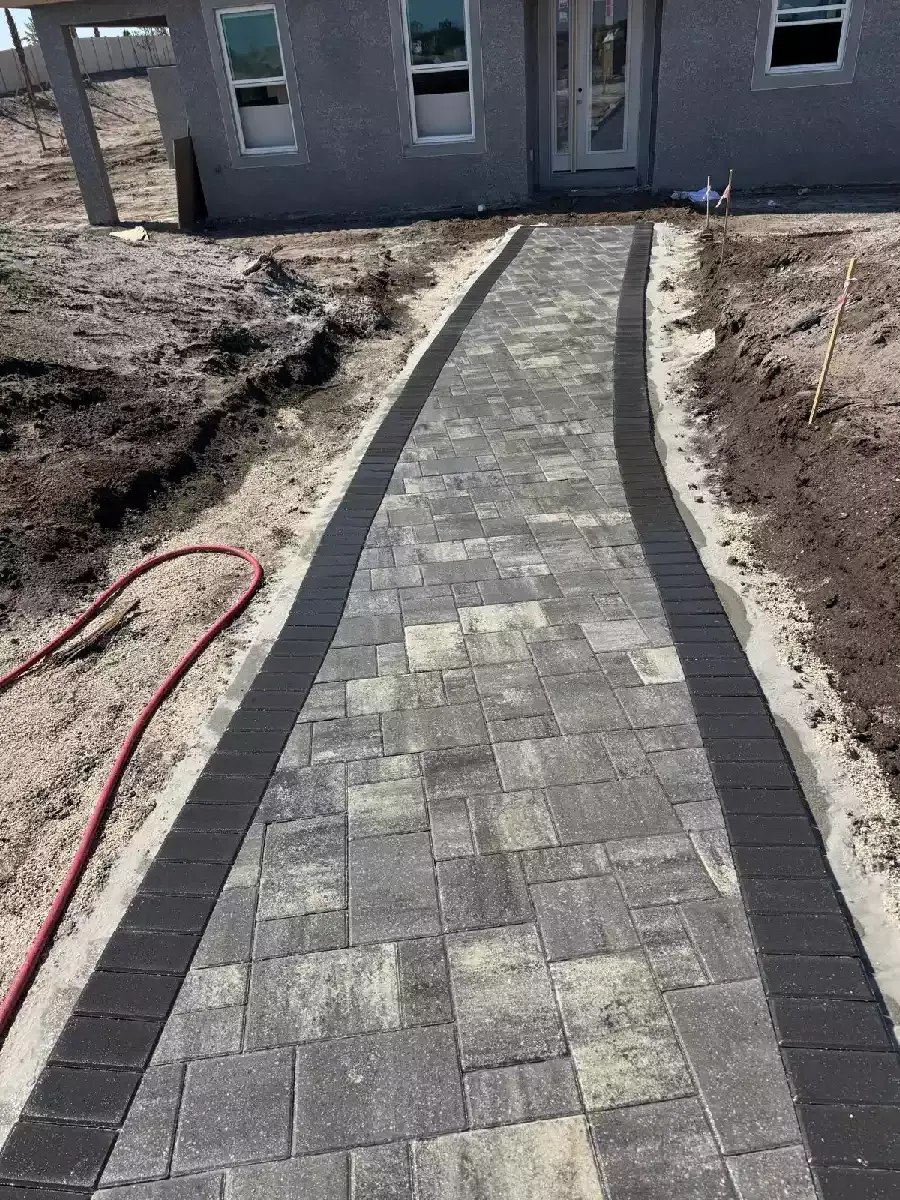 Concrete paver walkway with a dark border at a commercial development in North Port, Florida