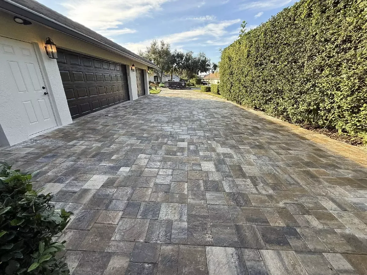 Gray multi-size concrete paver driveway beside a residential garage in Sarasota, Florida
