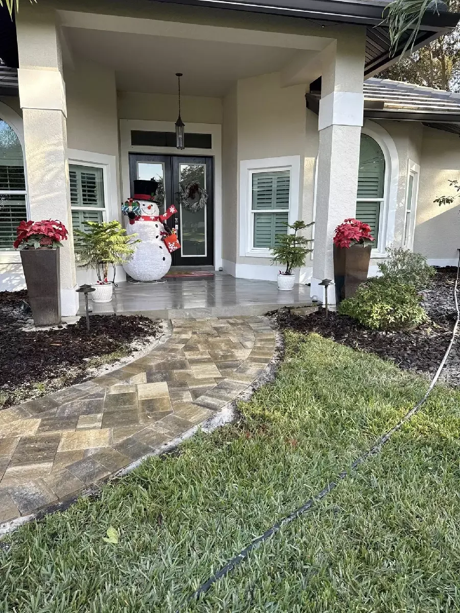 Curved paver walkway leading to a residential front entrance in Sarasota, Florida