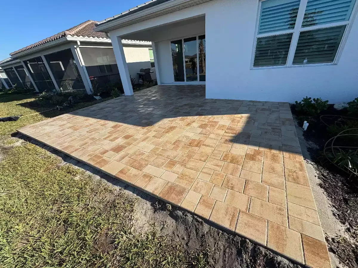 Completed brick paver patio behind a residential home in Venice, Florida