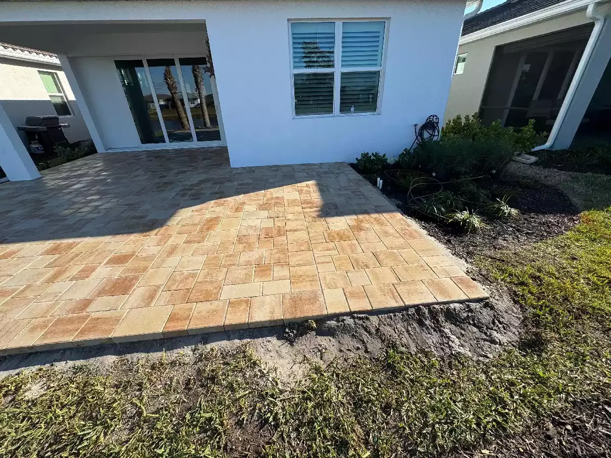 Completed concrete paver patio behind a residential home in Venice, Florida