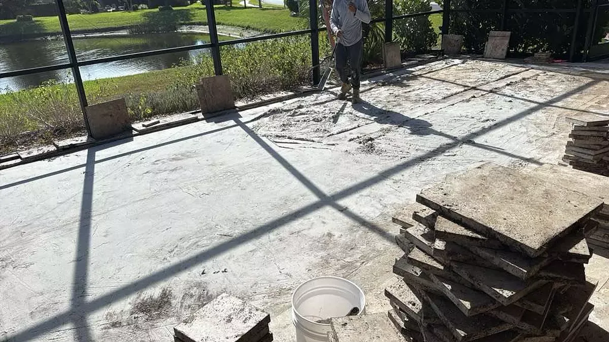 Settled and uneven concrete pavers on a lanai floor before repair in Venice, Florida