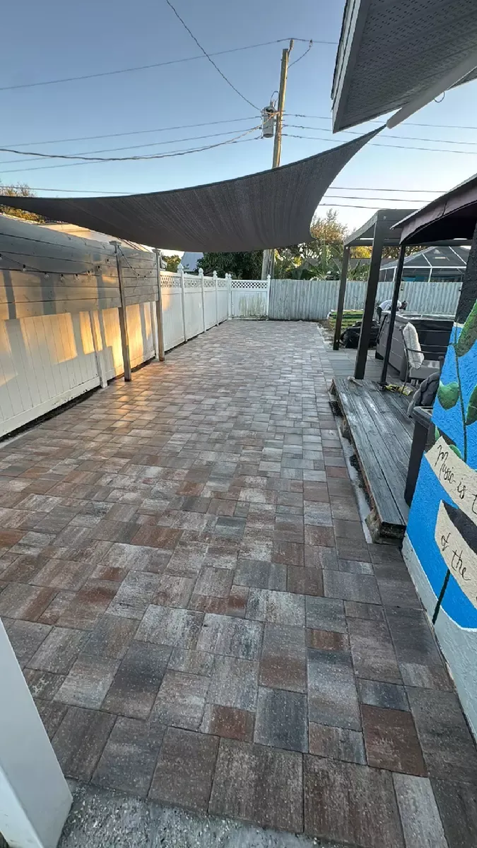 Sealed tan concrete paver patio behind a residential home in Venice, Florida