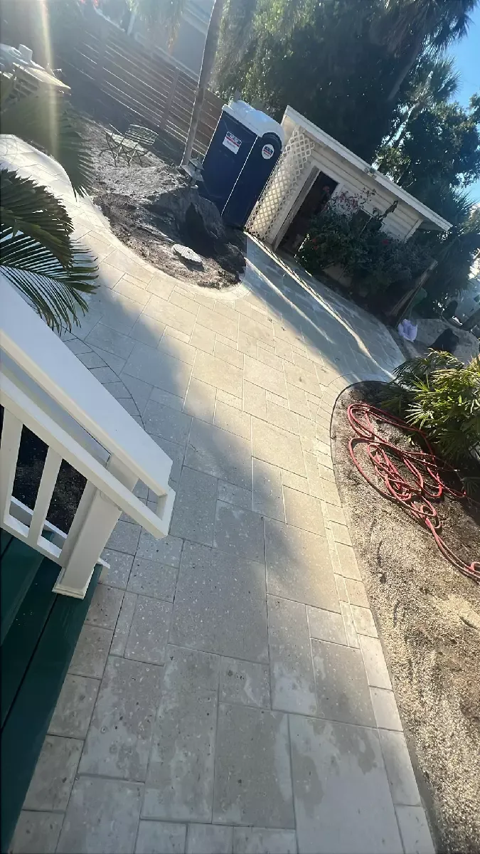 Light tan concrete paver patio with a curved edge after maintenance on Venice Island, Florida